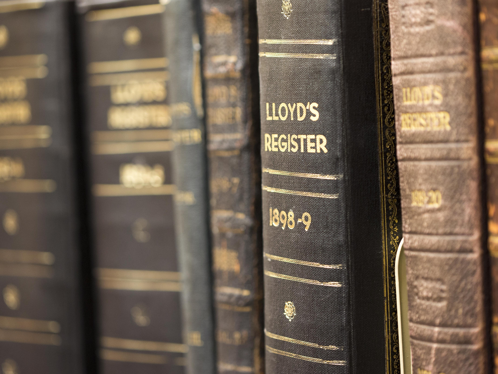 Shelf in library with copies of Lloyd's Registers. 