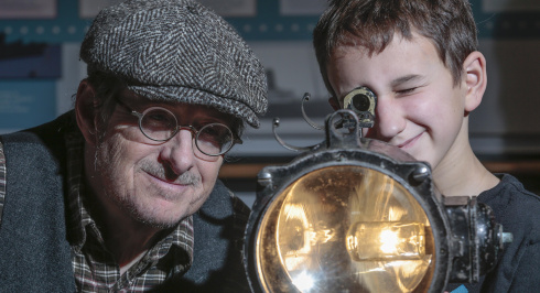 Man and a child looking at a light.
