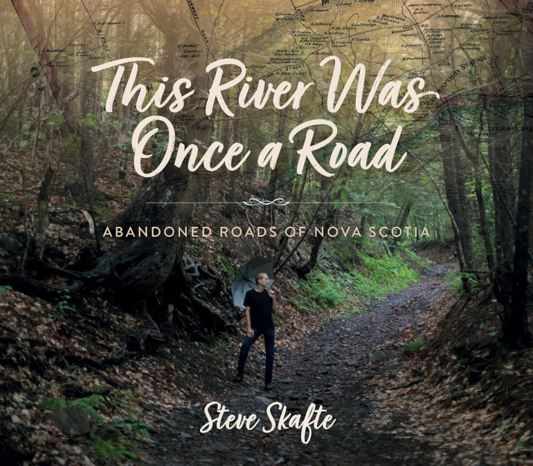 The book cover for this river was once a road by Steve Skafte, who is standing in the middle of a dirt road in the woods.