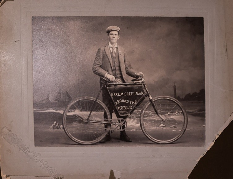 a black and white image of Karl Creelman and his bicycle.