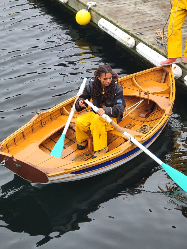 A student learning to row a yawl in Halifax Harbour.