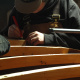 A student building the frame of a boat in the boat shed at the Maritime Museum of the Atlantic.