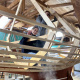 A student building the frame of a boat in the boat shed at the Maritime Museum of the Atlantic.