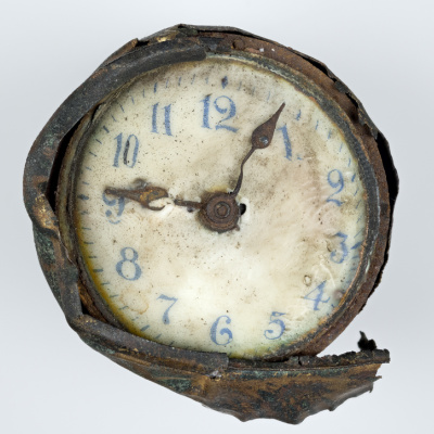 Clock found in explosion wreckage, front.