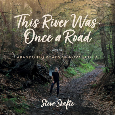 The book cover for this river was once a road by Steve Skafte, who is standing in the middle of a dirt road in the woods.