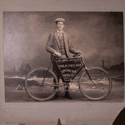 a black and white image of Karl Creelman and his bicycle.
