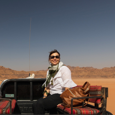 Louise Trotter sitting in the back of a truck in the desert. 