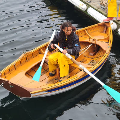 A student learning to row a yawl in Halifax Harbour.