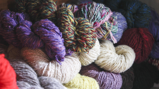 Skeins of wool in a pile.